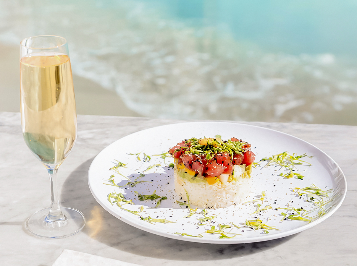 a plate of food and a glass of champagne