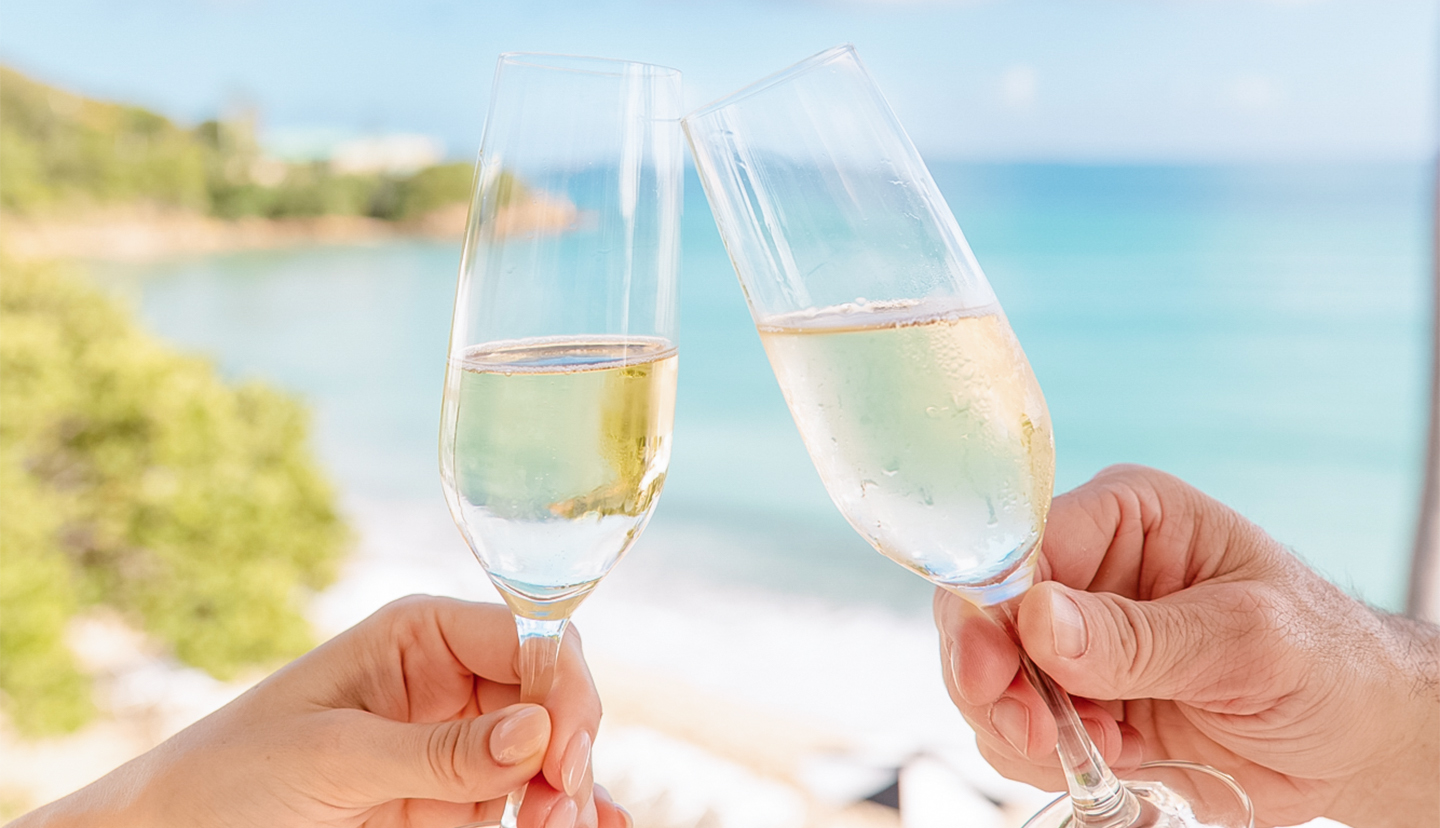 a pair of hands holding champagne glasses