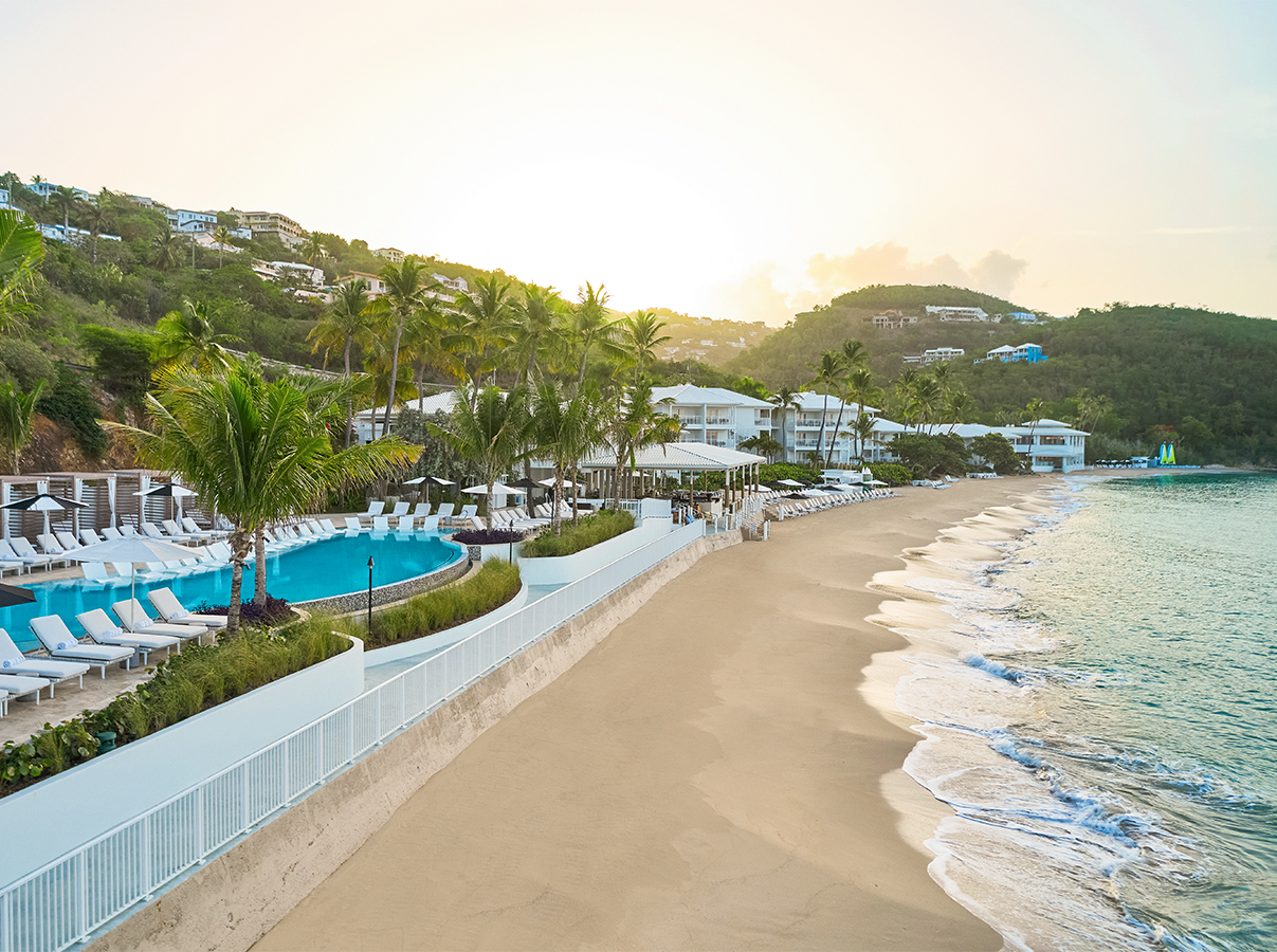 a beach with a pool and palm trees