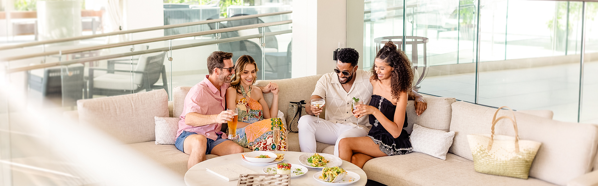 a group of people sitting on a couch with drinks