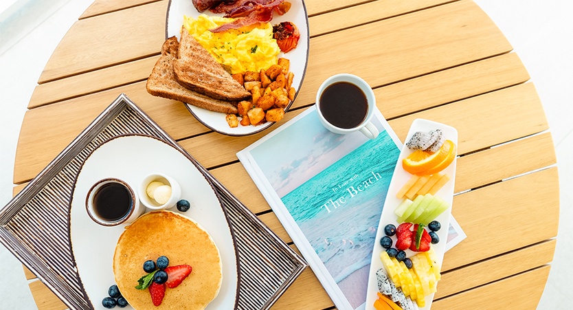 a plate of food and a cup of coffee on a table