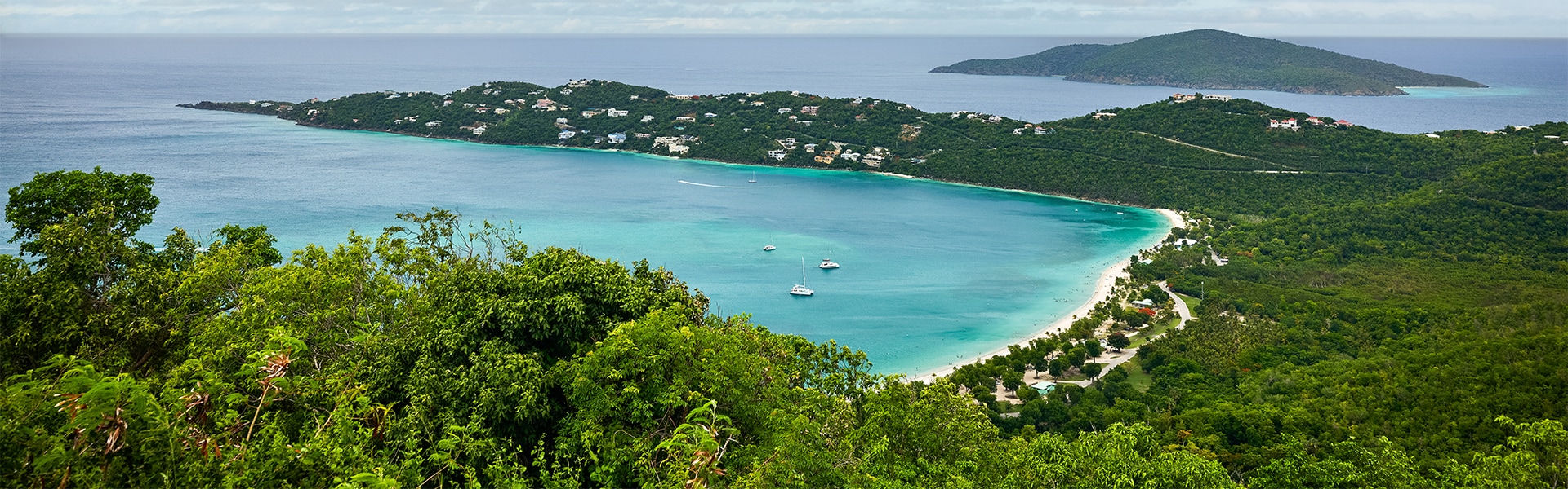 a body of water with boats and buildings in the distance