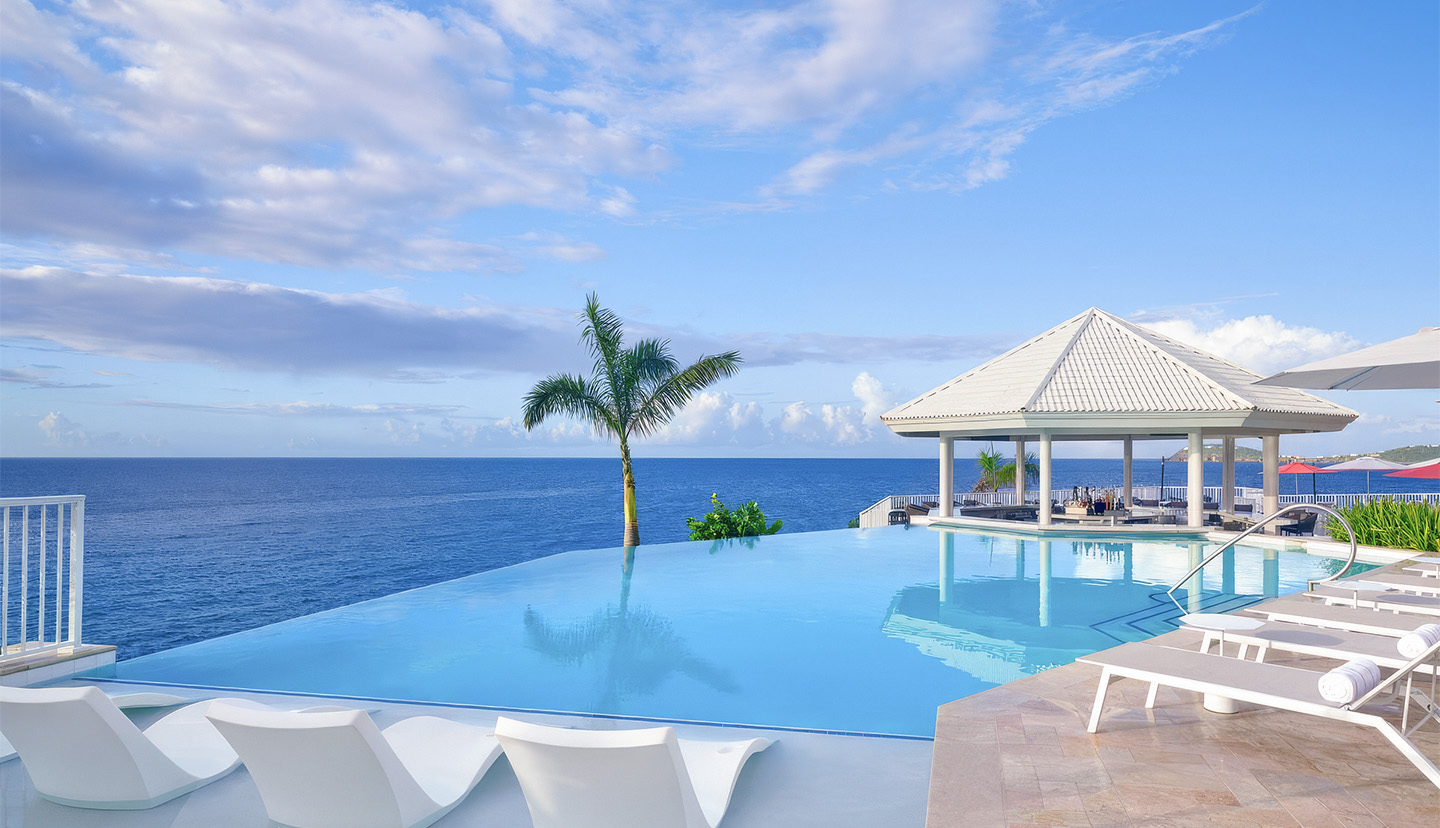 a pool with a gazebo and a palm tree