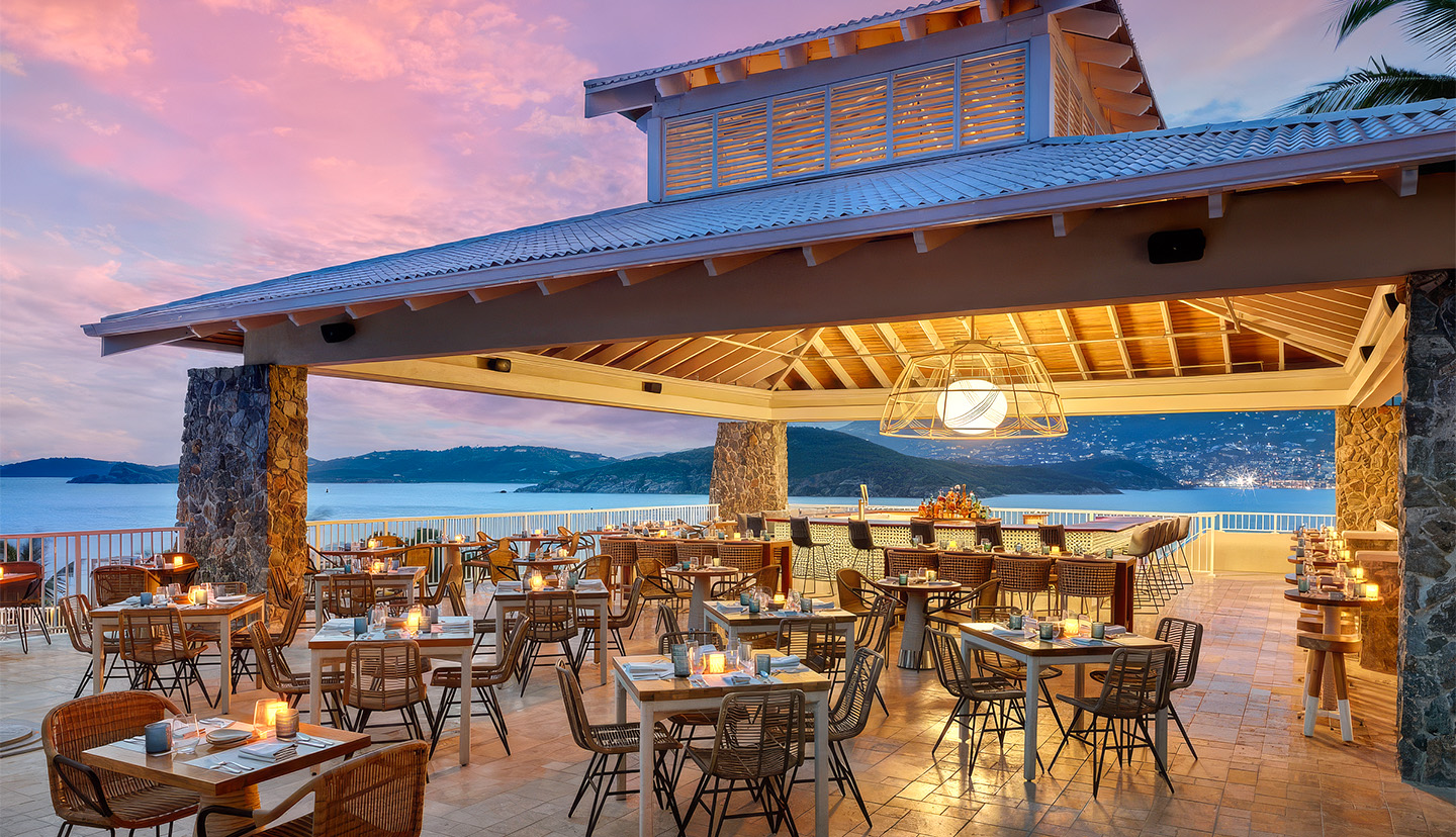 a restaurant with tables and chairs on a tile patio