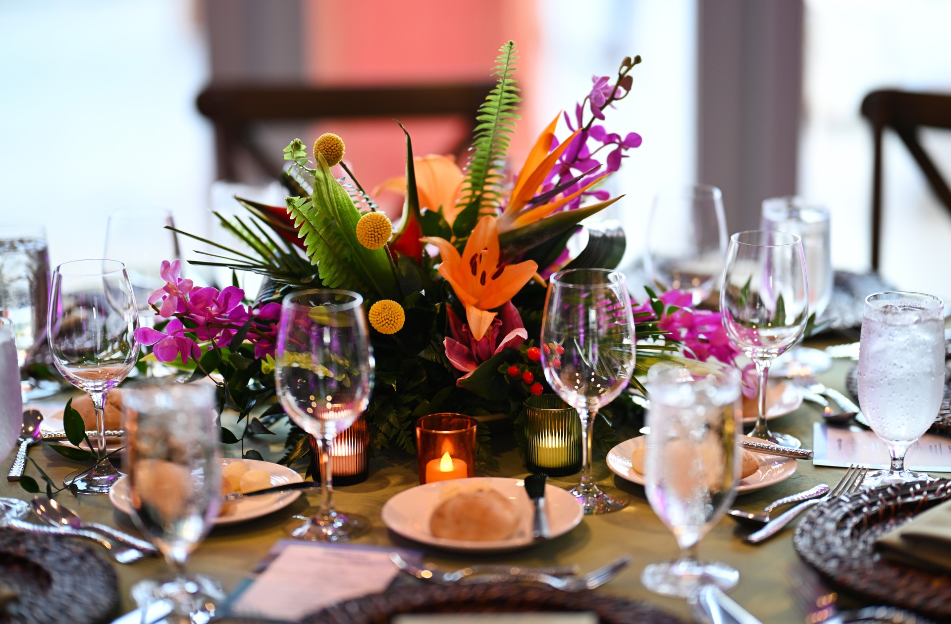 a table set with flowers and glasses