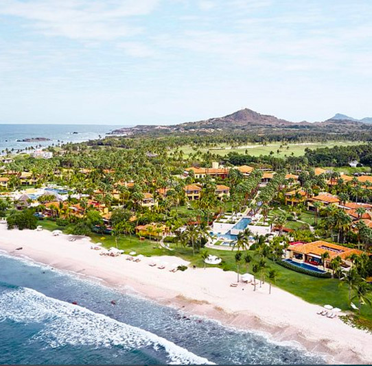 a beach with houses and trees