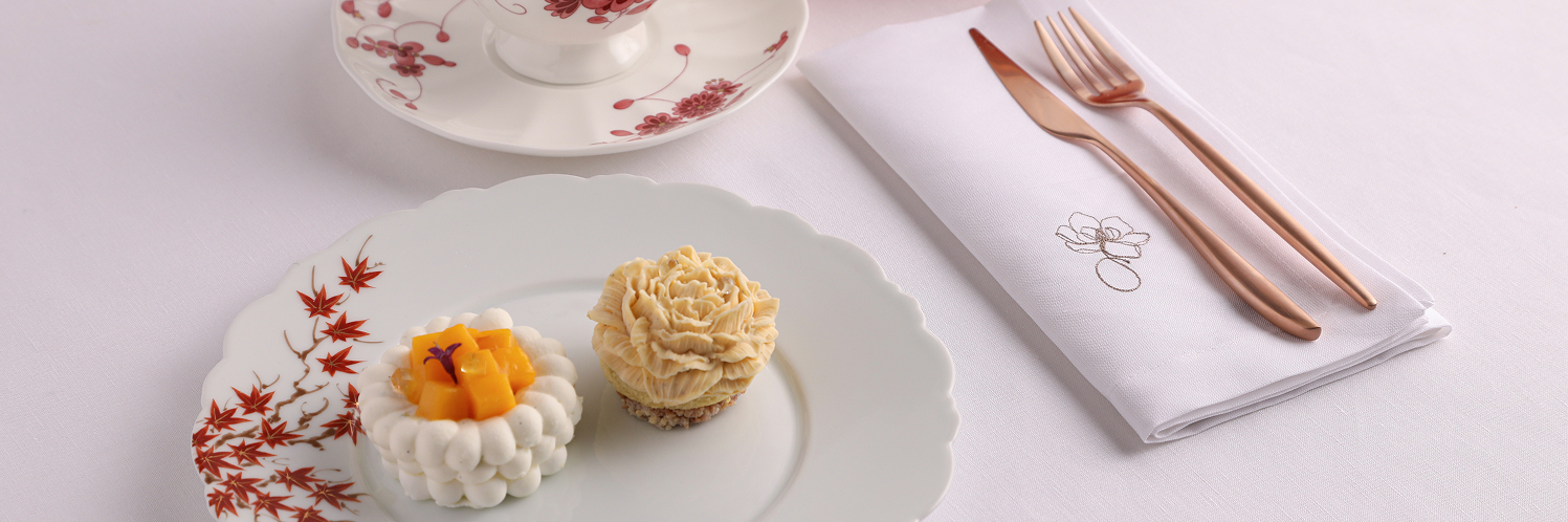a plate of desserts and a cup of tea