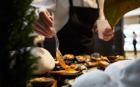 a person holding a fork over a plate of food