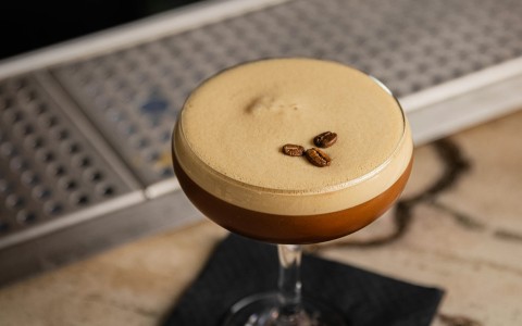 a drink with coffee beans on top