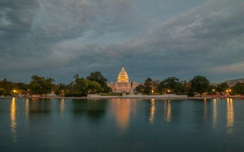 a large building with a dome in the distance