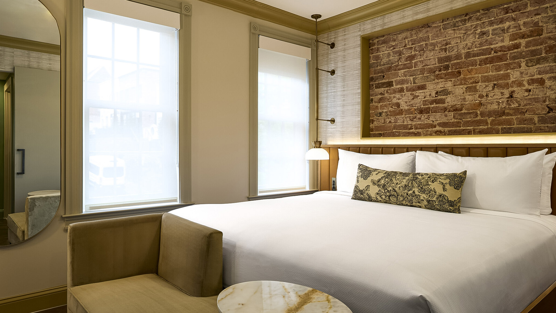 a bed with a marble table and a brick wall