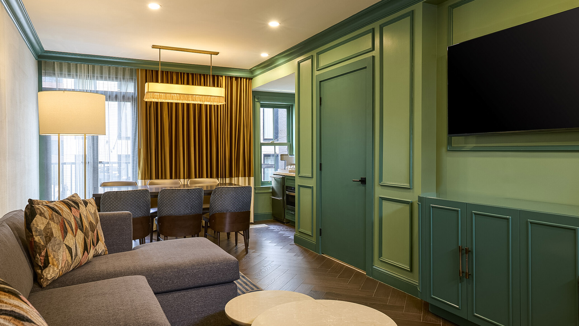 a living room with green walls and a green door