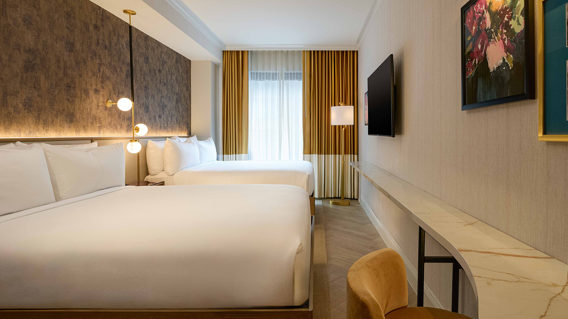 a room with two beds and a television