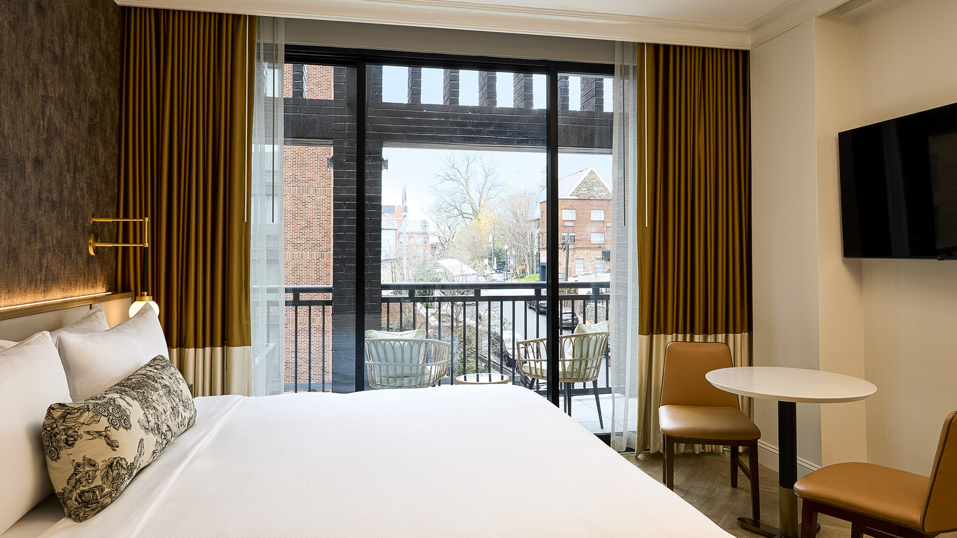 a room with a balcony and a bed