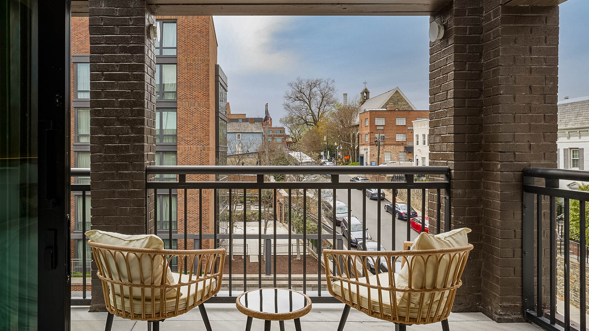a balcony with chairs and a table