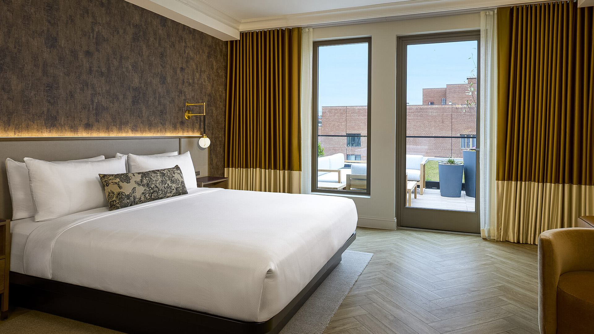 a bed in a room with a glass door