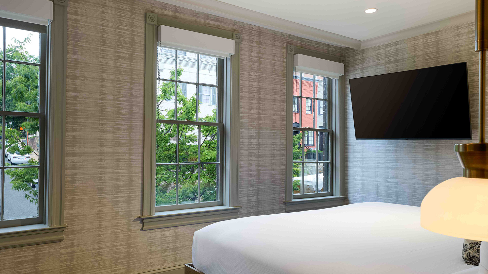 a bedroom with a bed and windows