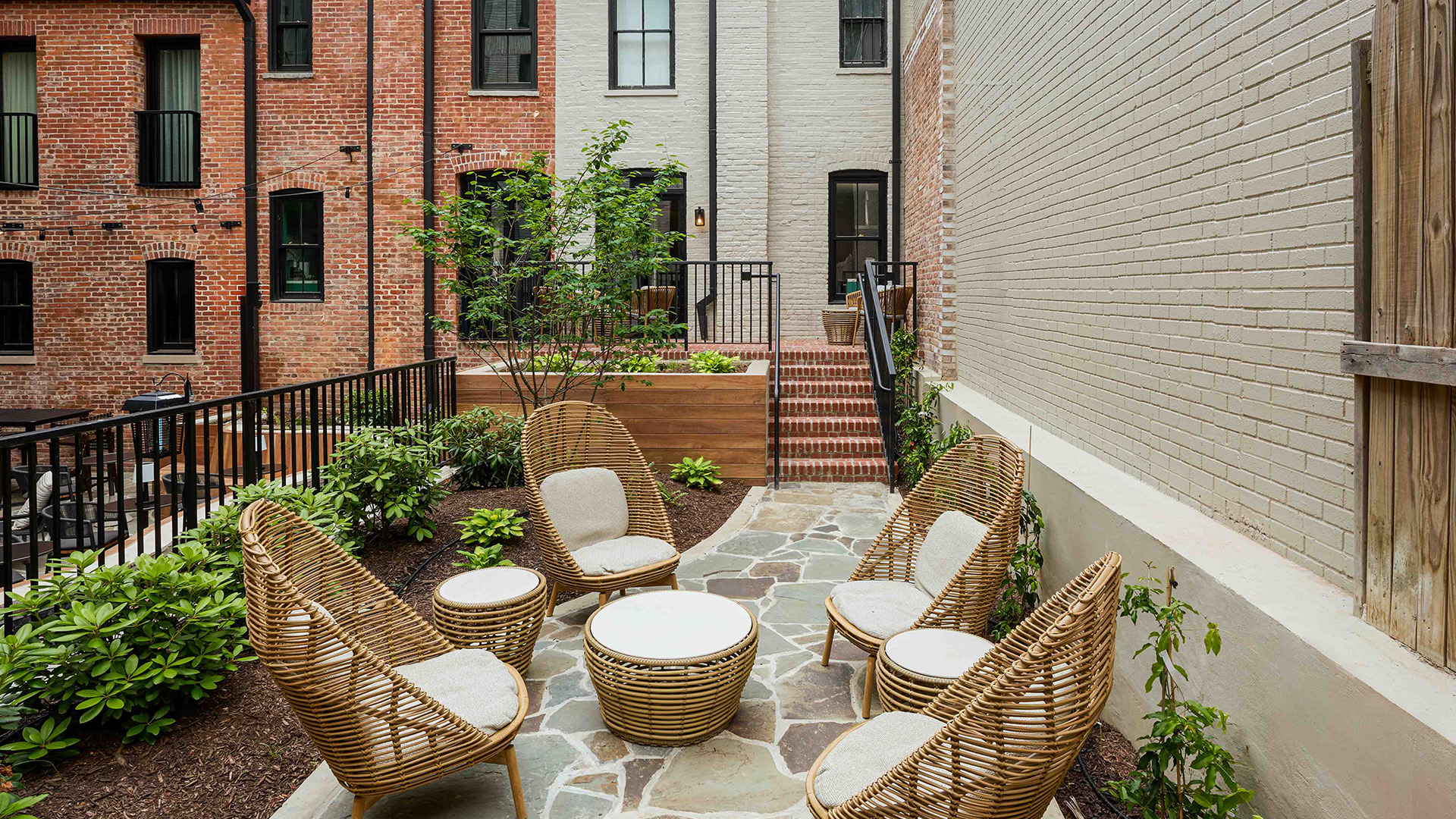a patio with chairs and a table