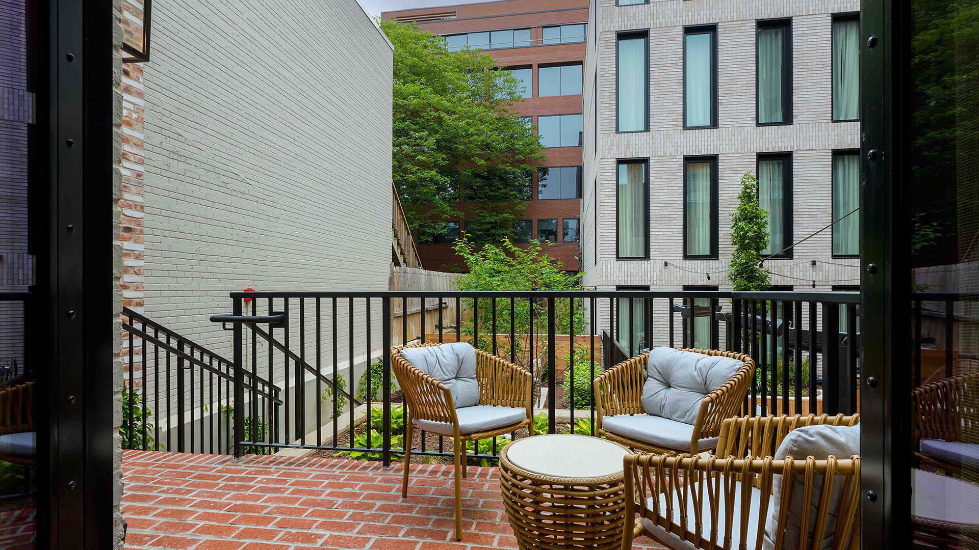 a patio with chairs and a coffee table