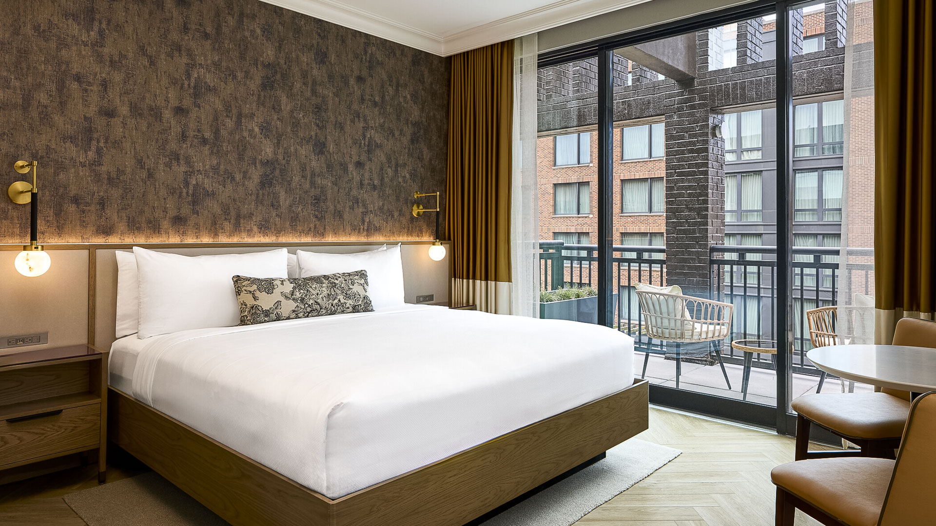 a bed with a glass door and a chair outside