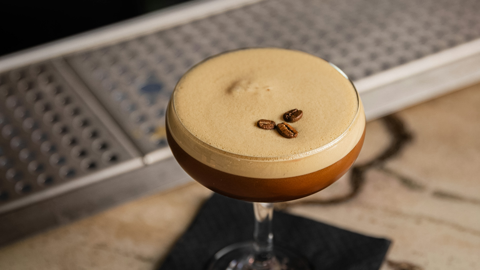 a drink with coffee beans on top