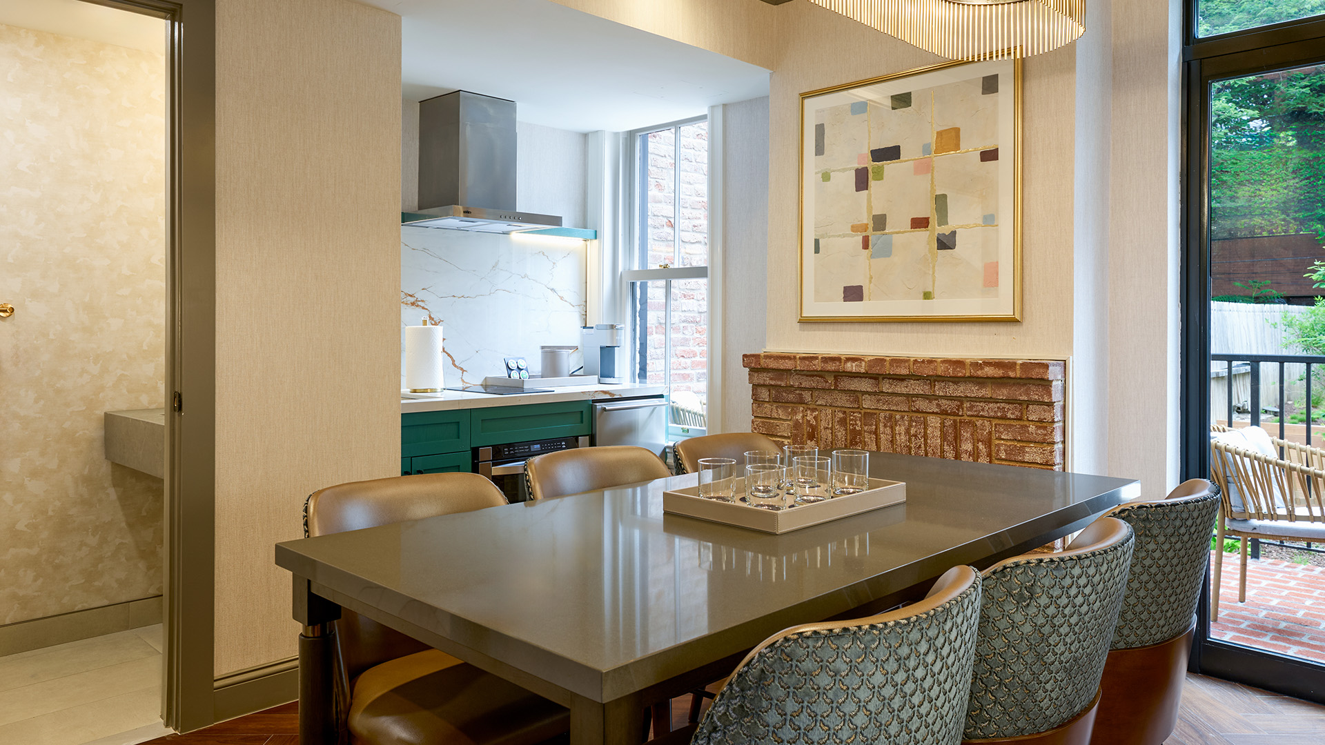 a dining table with chairs and a painting on the wall