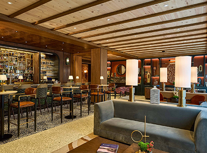 a room with a couch and tables and chairs