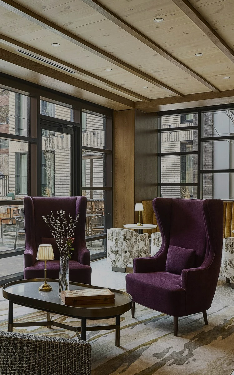 a room with purple chairs and a coffee table