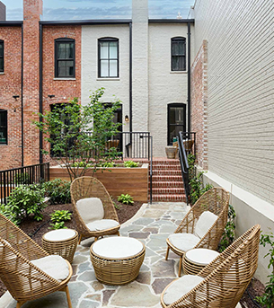 a patio with chairs and a table