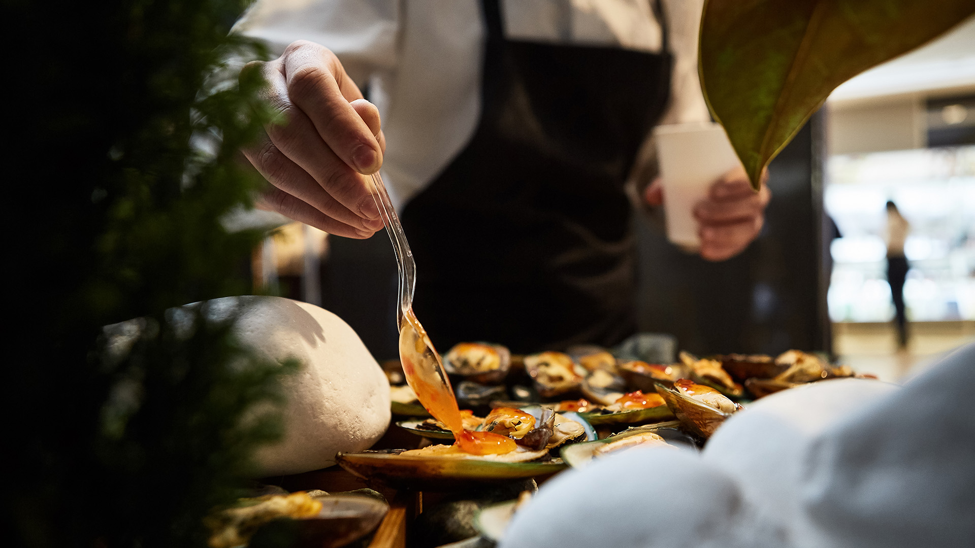 a person holding a fork over a plate of food