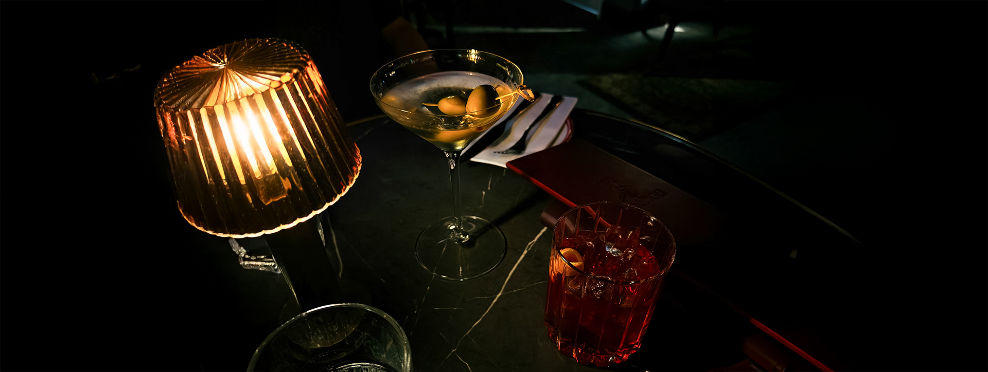 a martini glass with olives on it