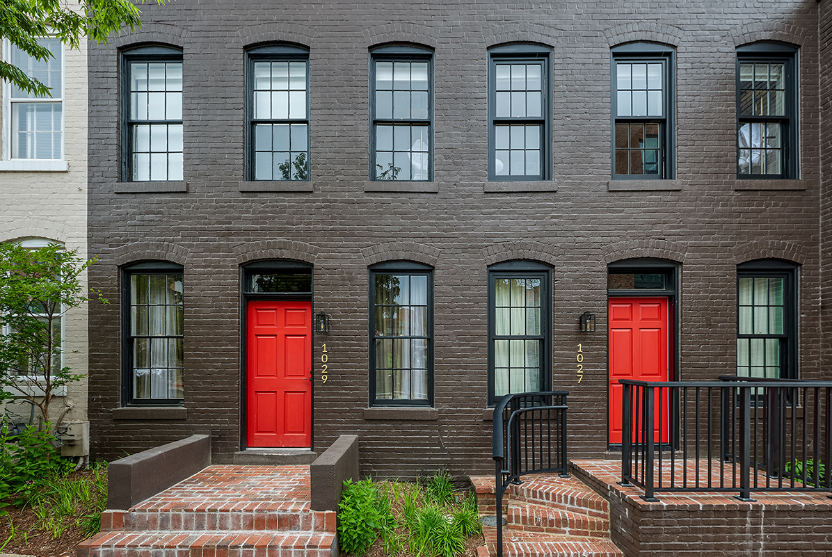 a building with red doors and stairs