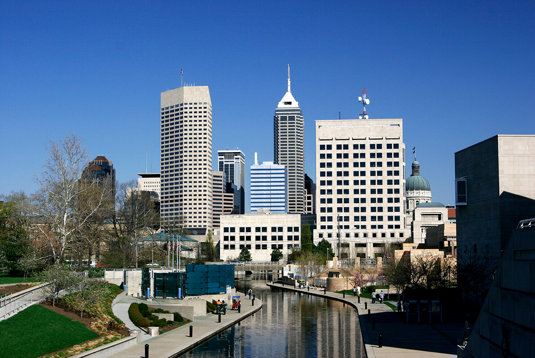 a city skyline with a canal and a path