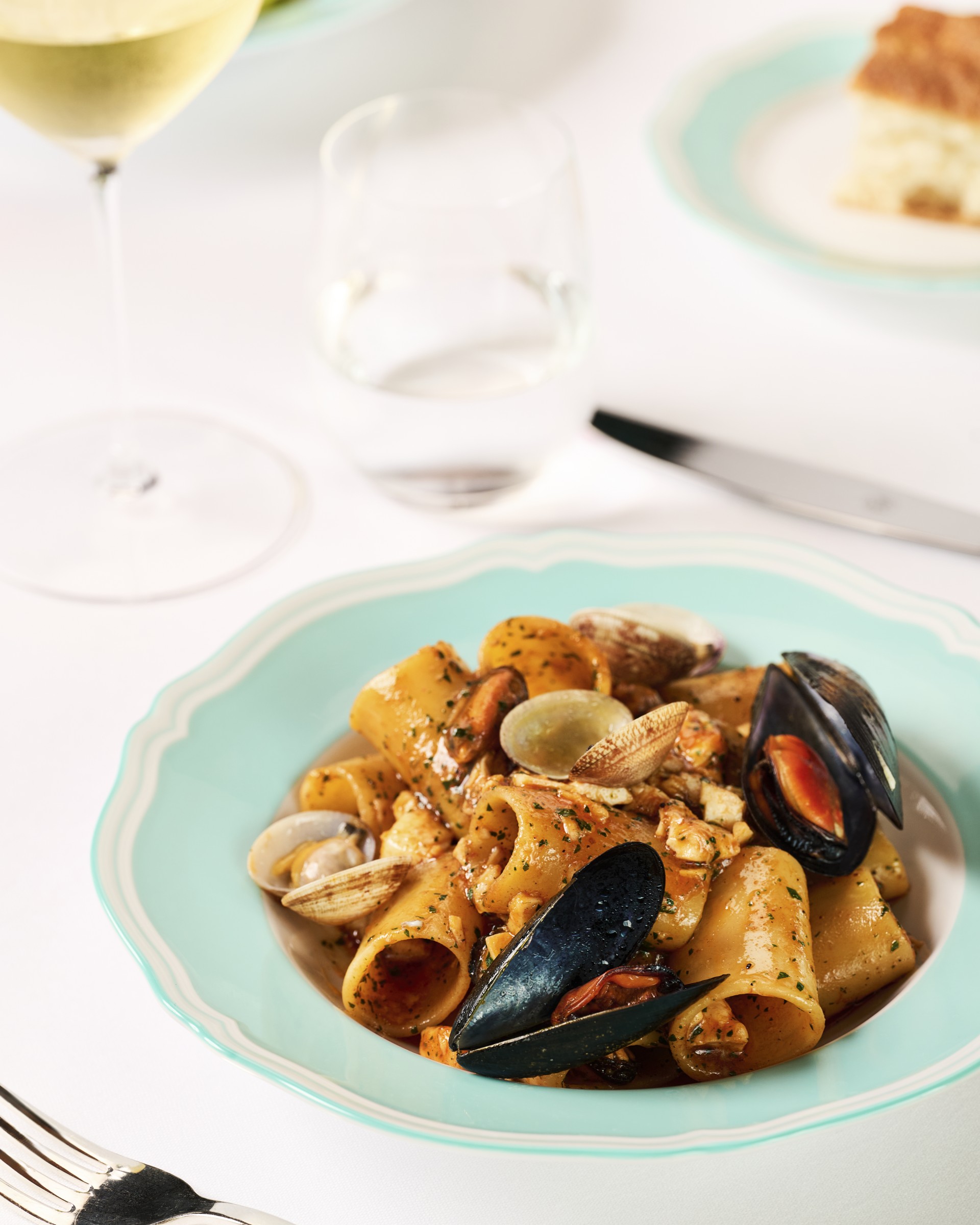 a plate of pasta with mussels and clams