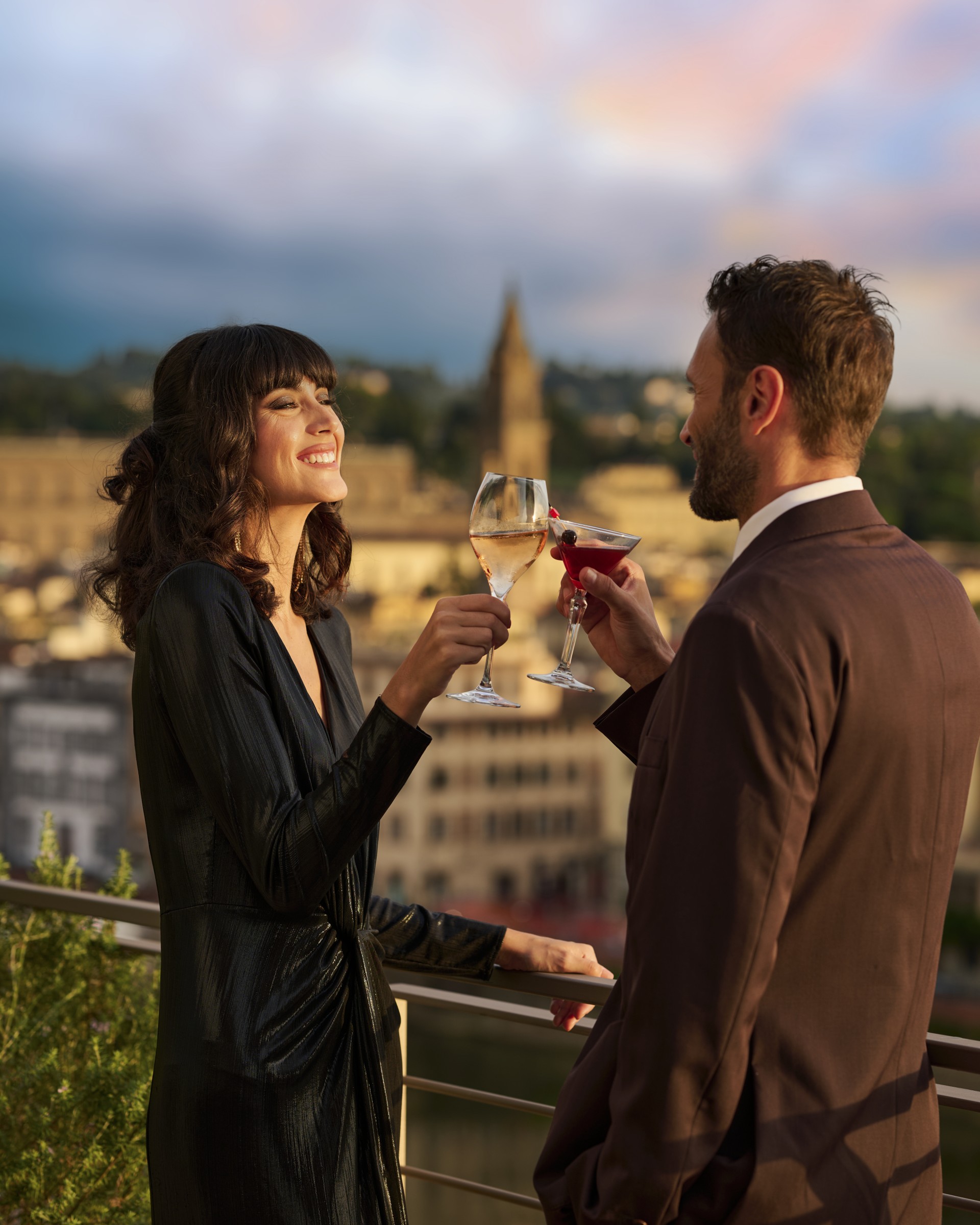 a man and woman holding wine glasses