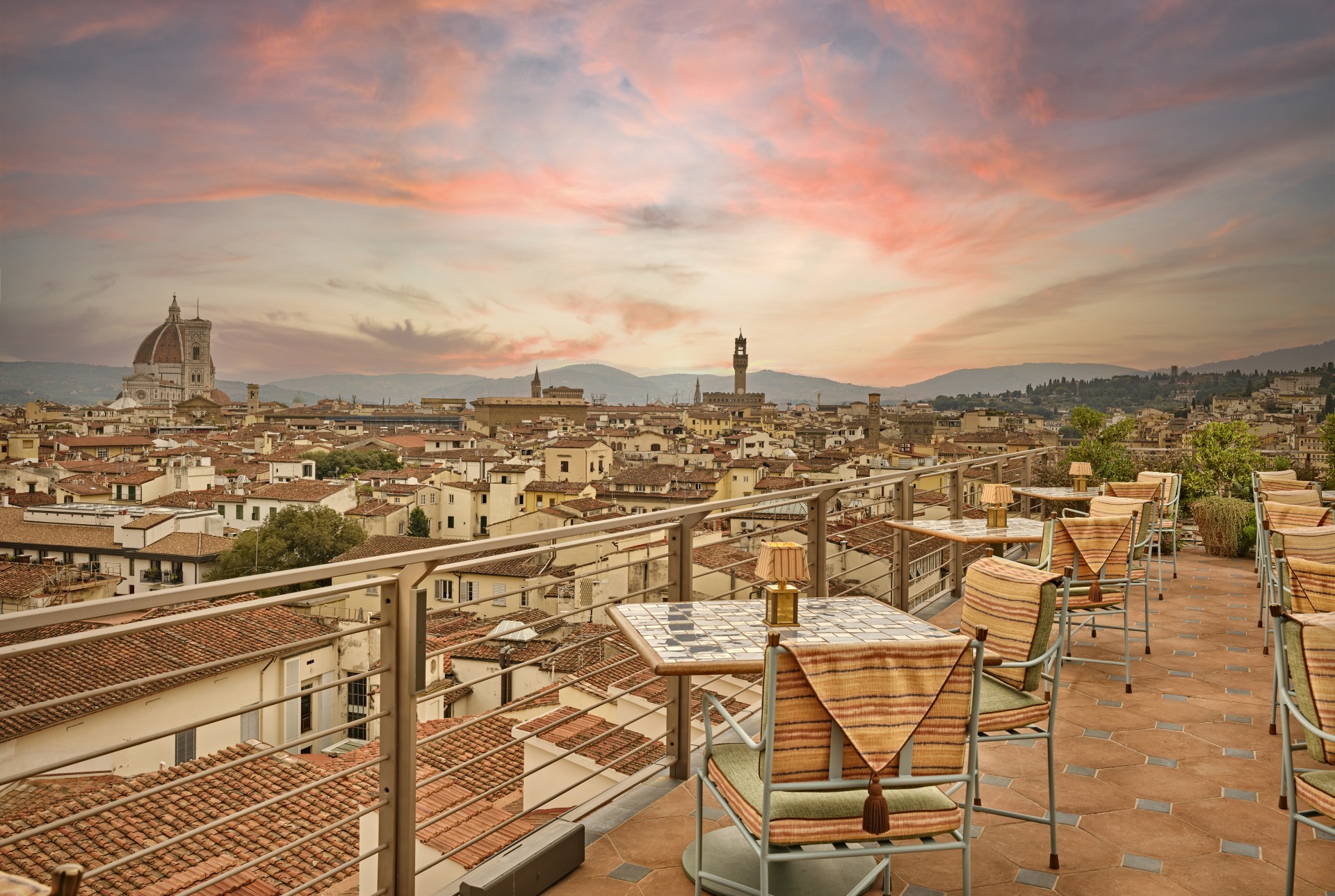 a rooftop restaurant with tables and chairs