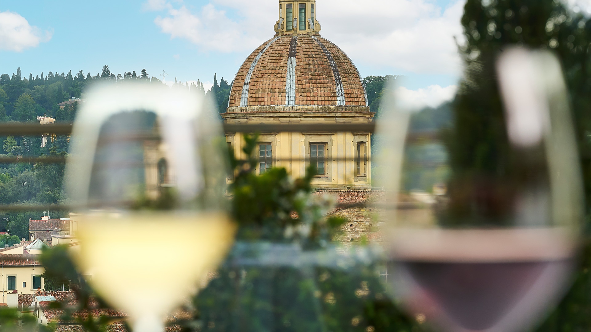 a glass of wine next to a building