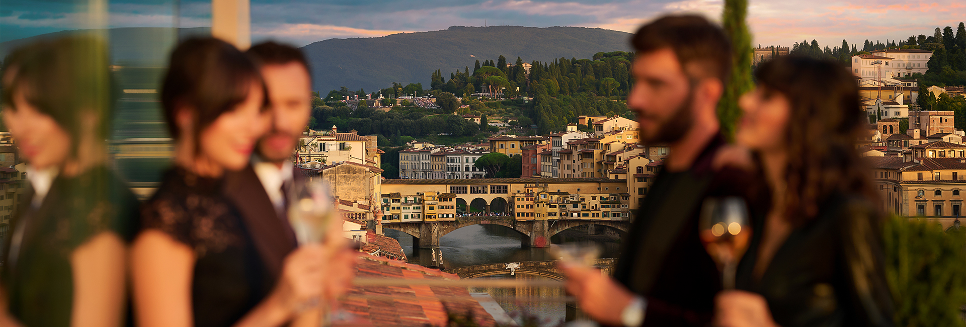 a group of people standing next to a bridge over a river