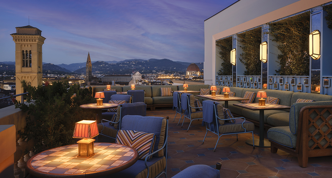 a rooftop patio with tables and chairs