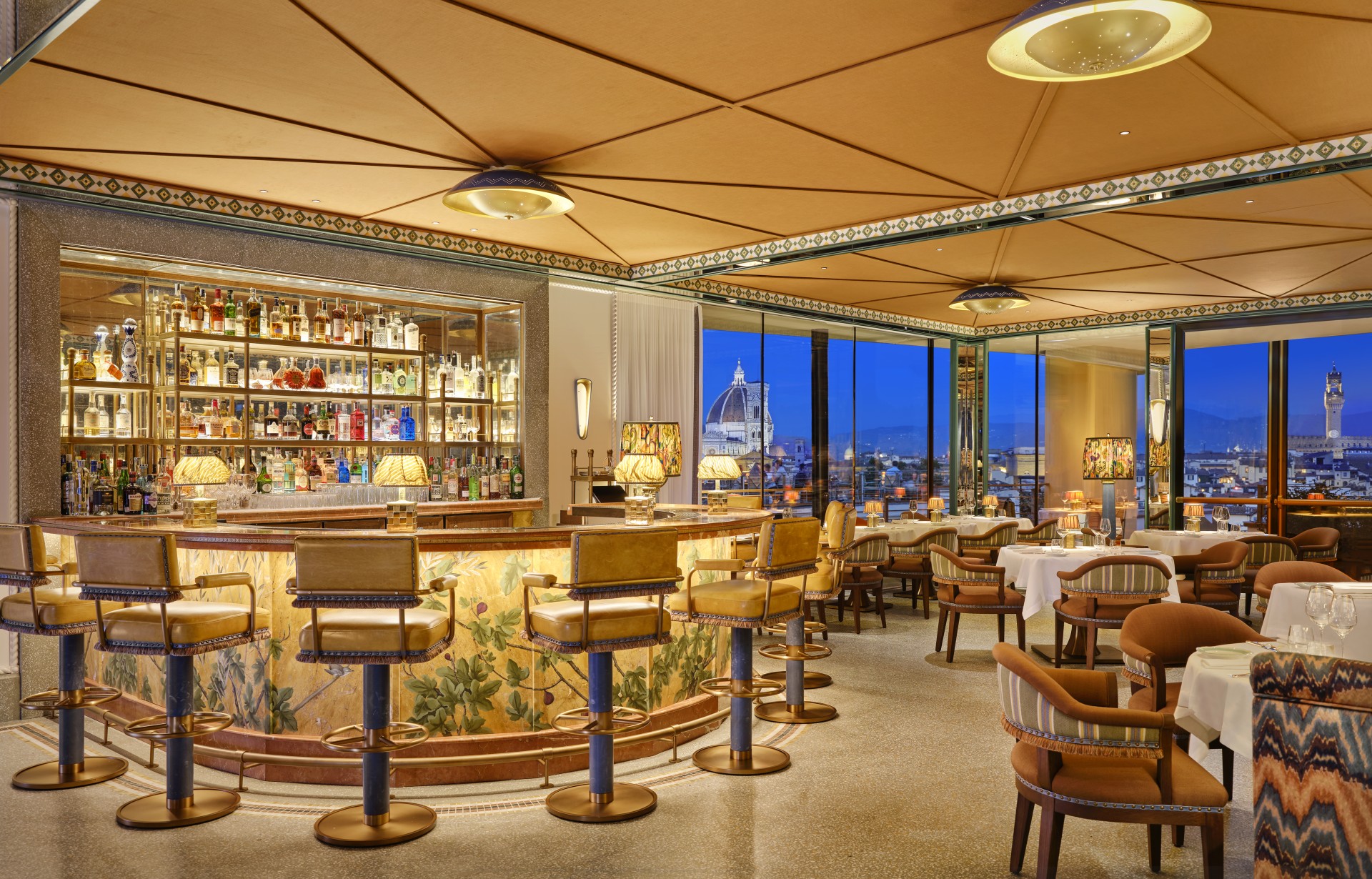 a bar with chairs and a table with a glass shelf