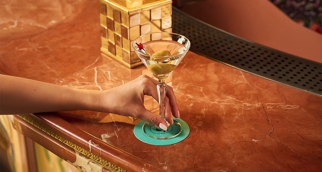 a hand holding a martini glass