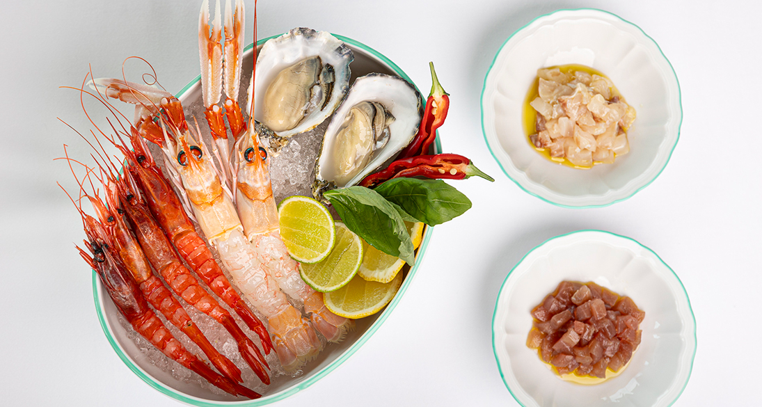 a bowl of seafood with shrimp and other food in it