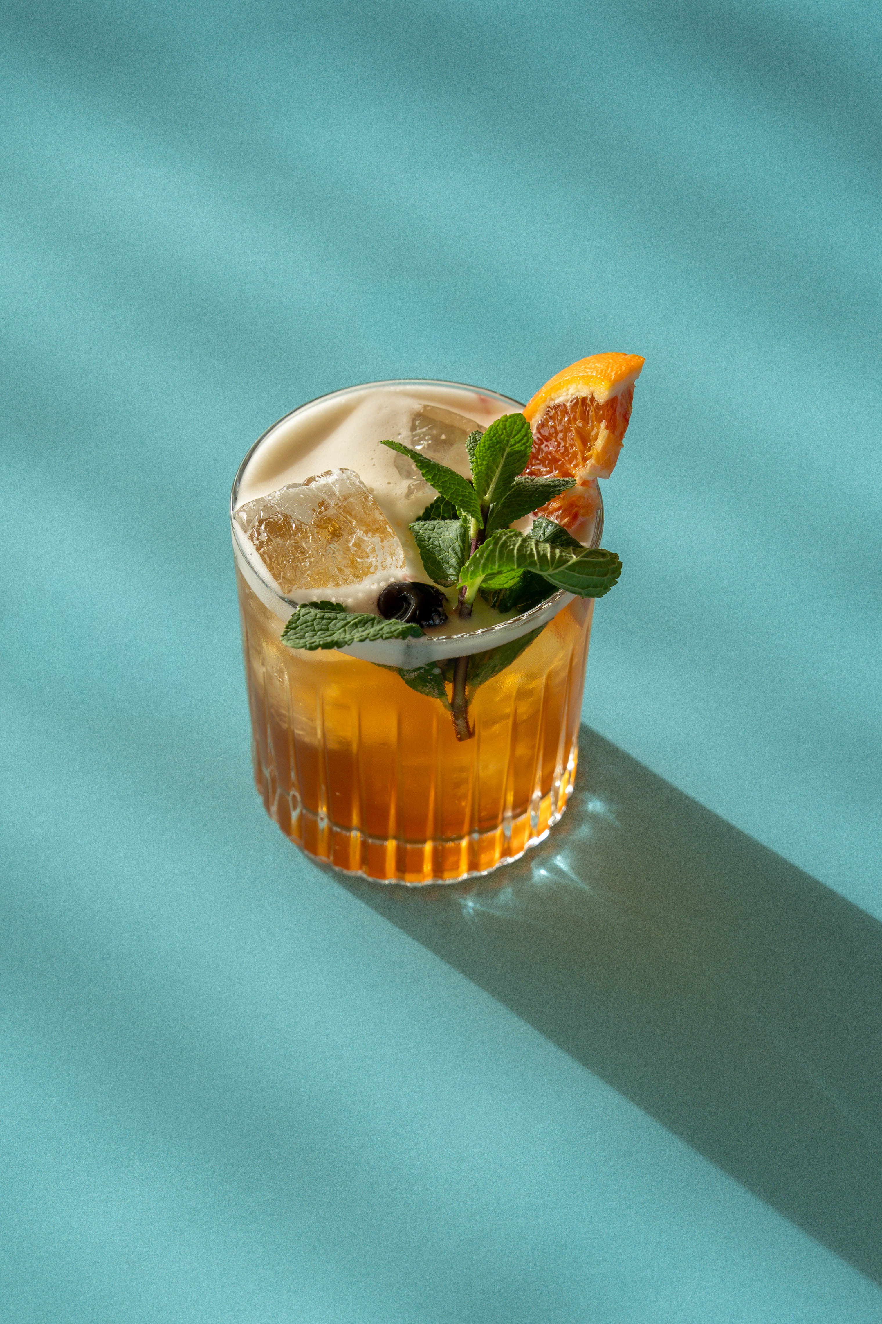 a glass with a drink and a slice of orange