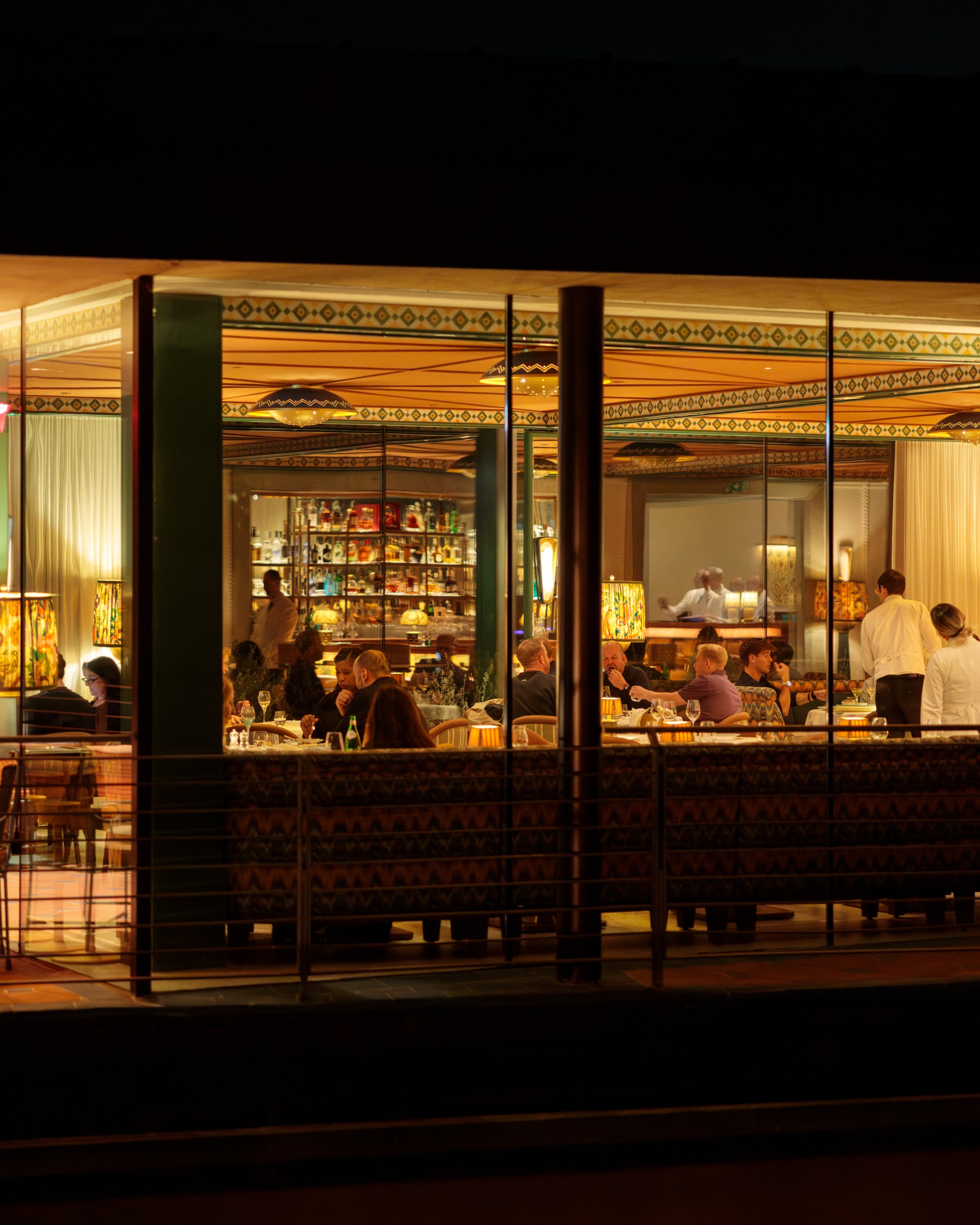 a group of people sitting at a table in a restaurant