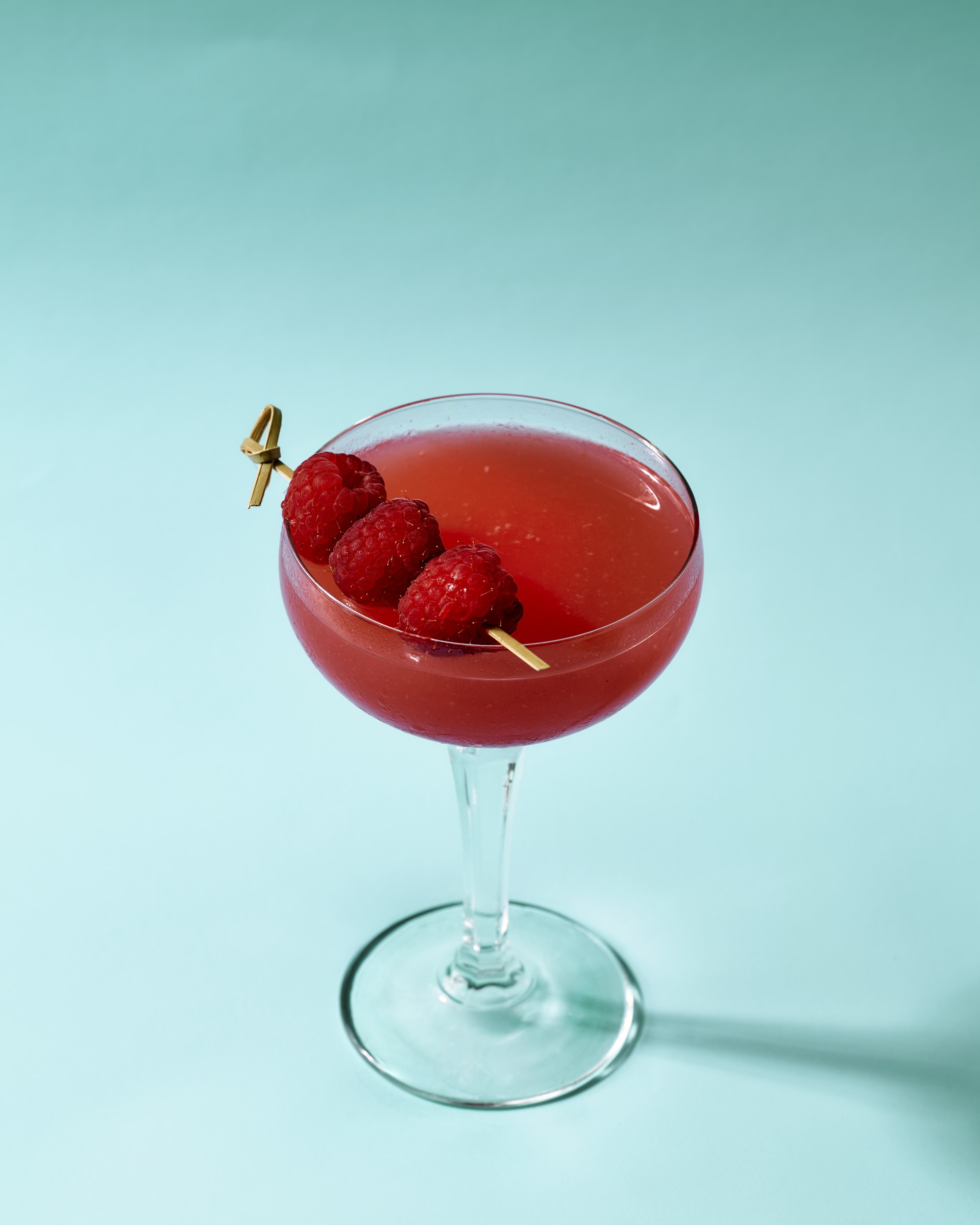 a glass with a drink and fruit on it