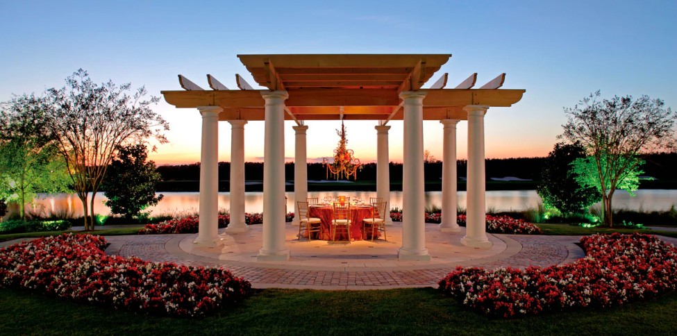 beautiful gazebo with open columns and small table situated under a chandelier