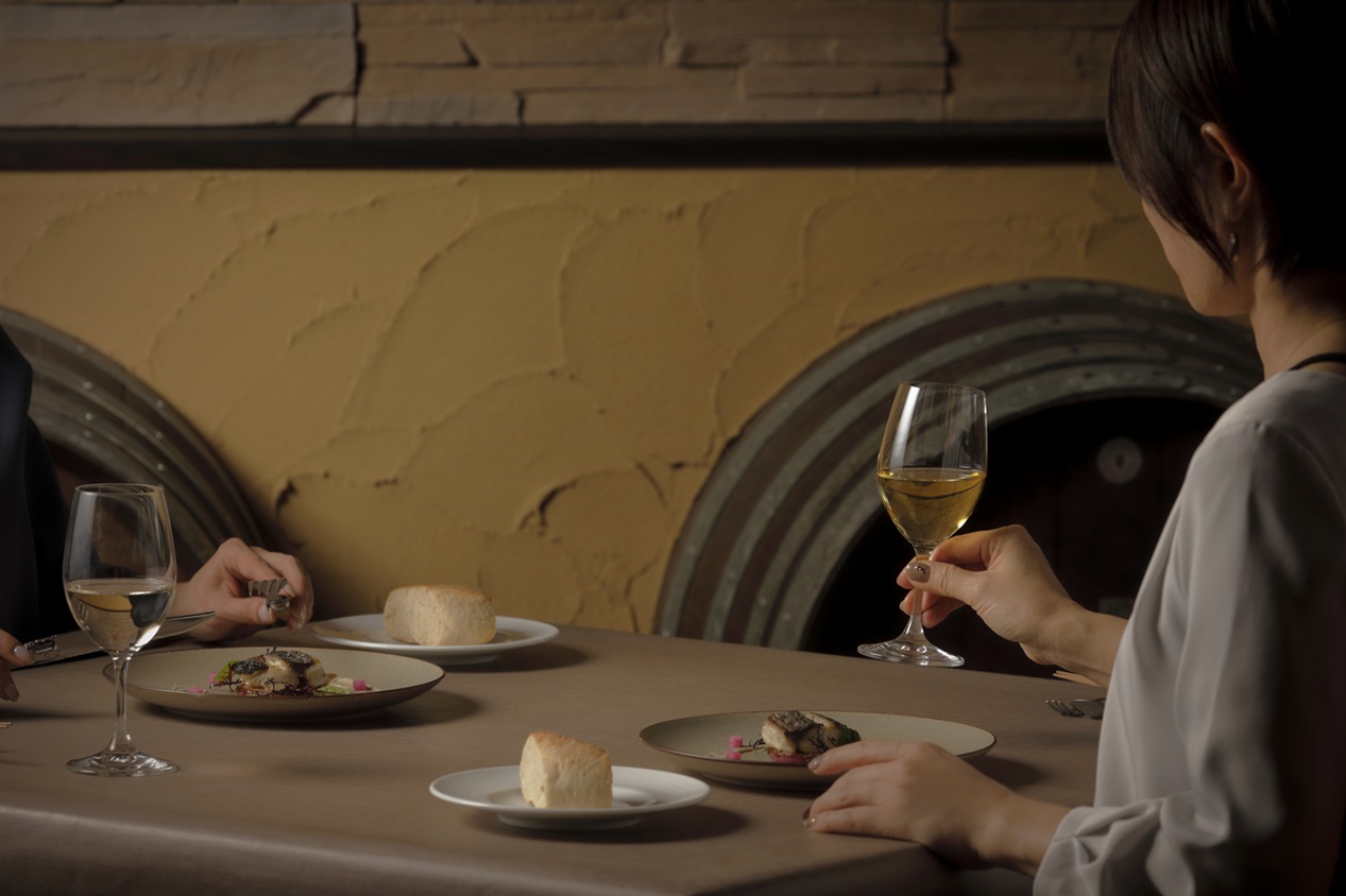 a couple of people eating at a table