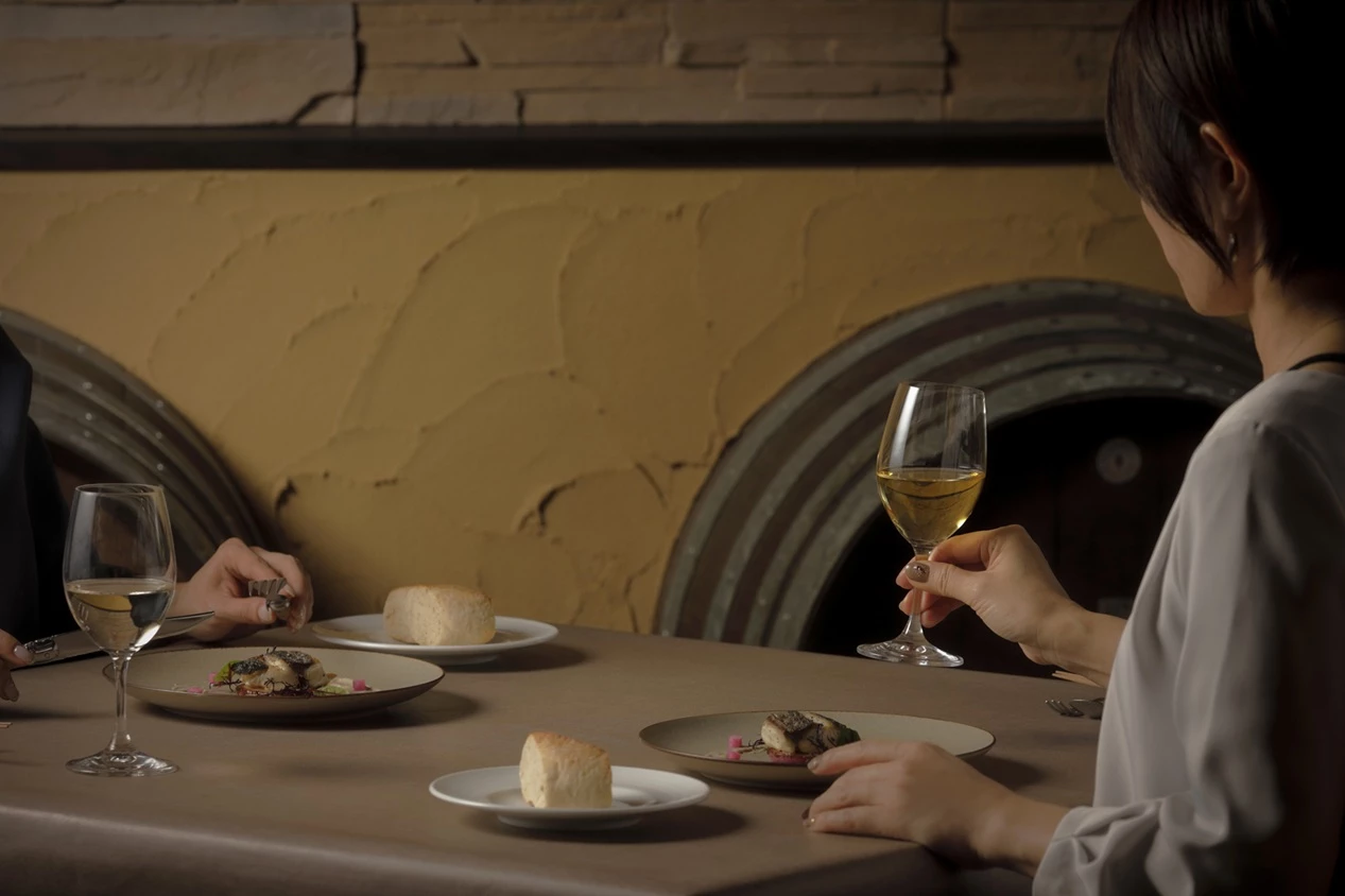 a couple of people eating at a table