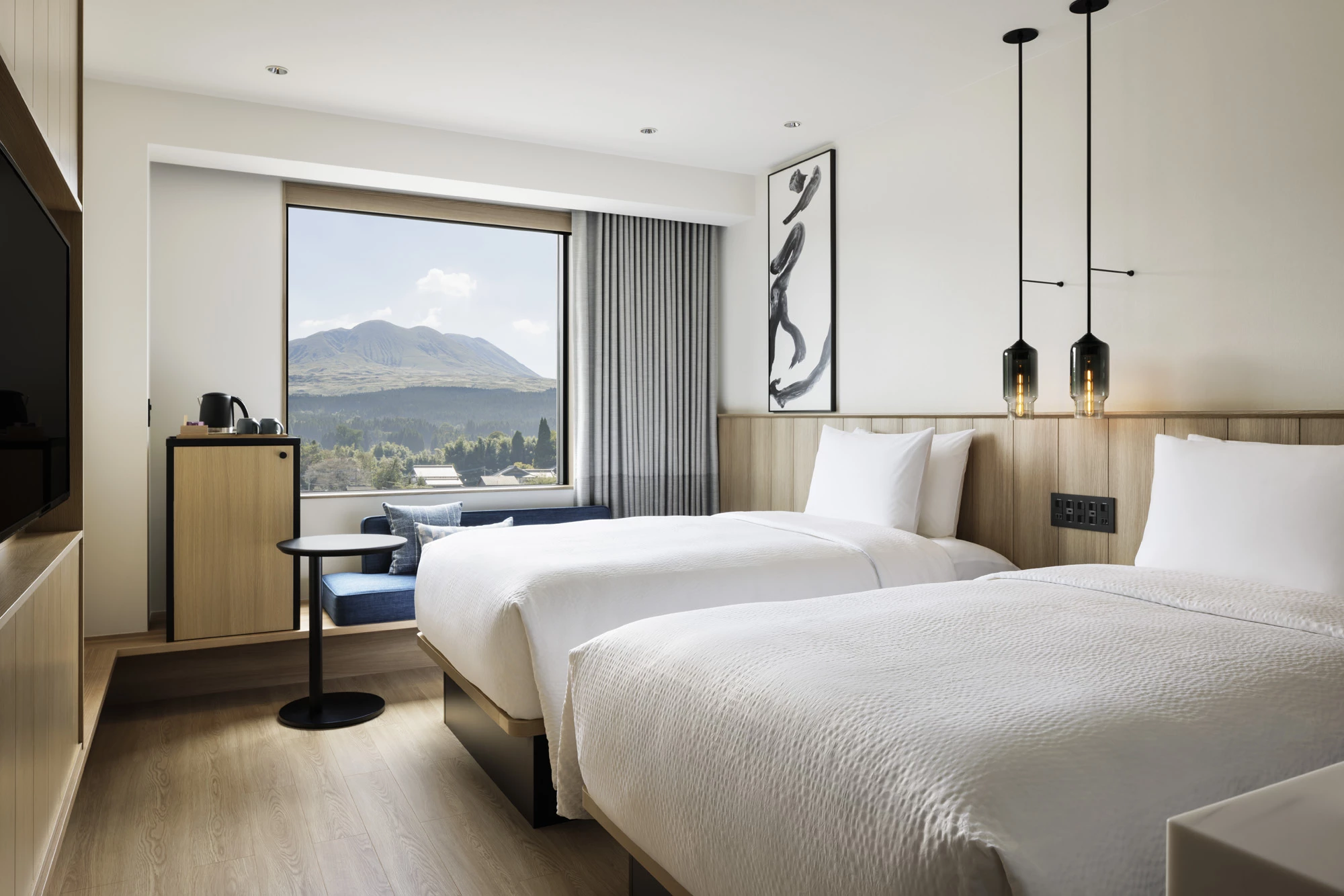 a room with two beds and a window
