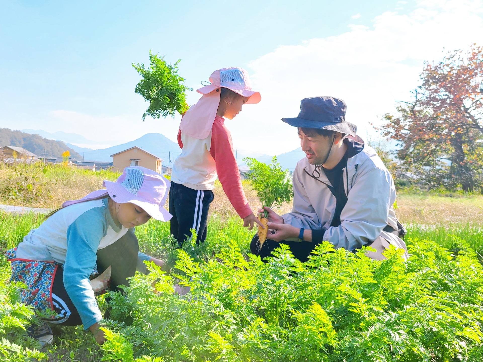 a man and two children in a field